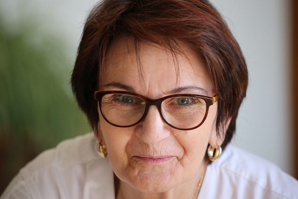 Older woman smiling with glasses